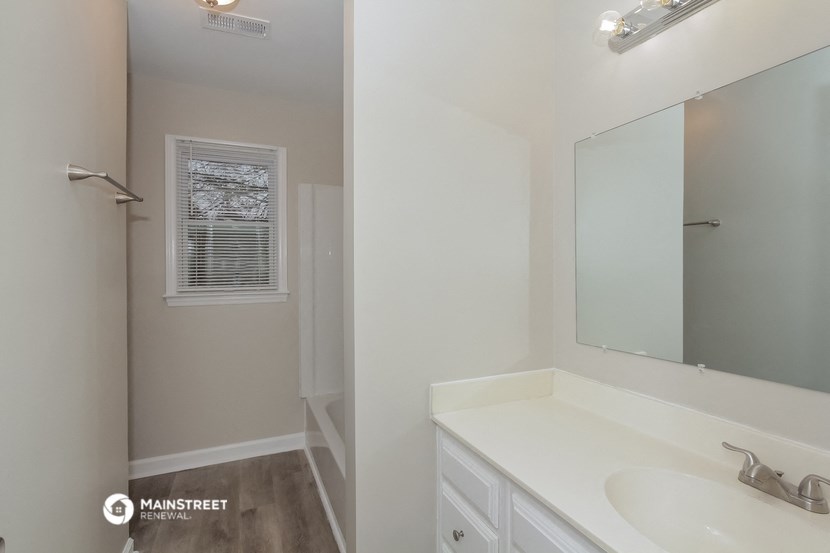 a bathroom with a sink and a mirror and a shower