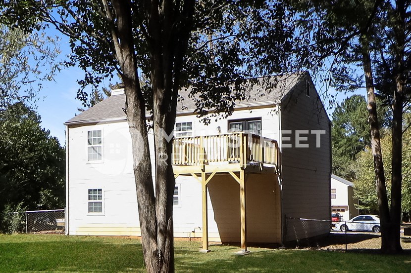 an image of a house with a deck on top of it
