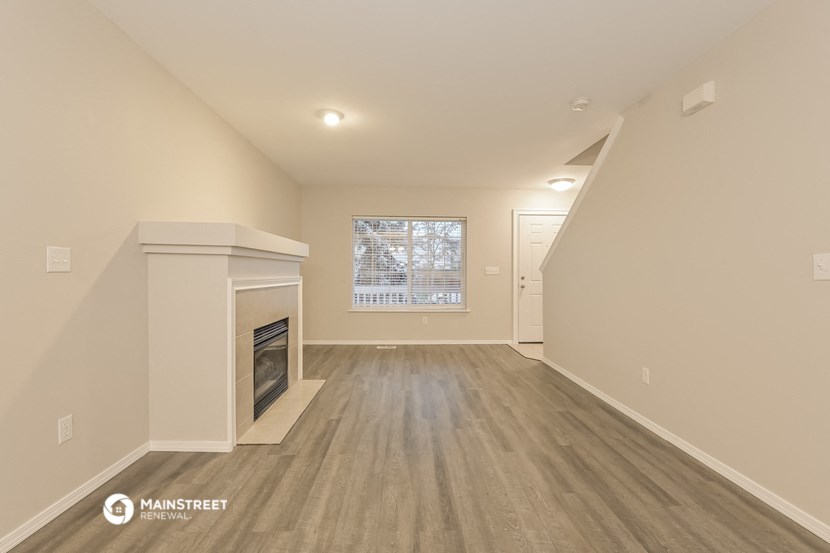 the living room with fireplace and hardwood floors