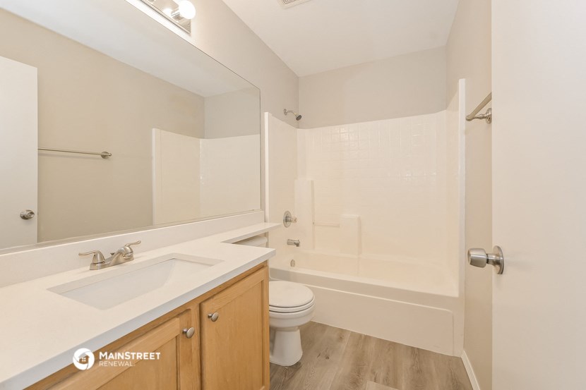 a bathroom with a sink and a toilet and a shower