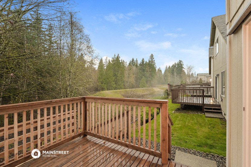 the view from the deck of a home with a wooden railing