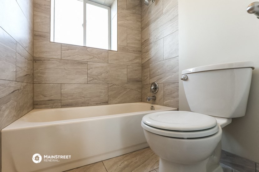 an image of a bathroom with a toilet and a bath tub