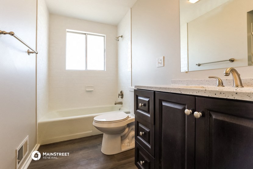 a bathroom with a toilet and a sink and a shower