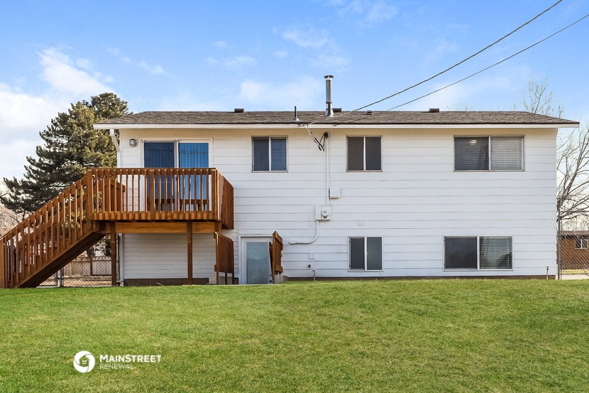 a white house with a deck on the side of it