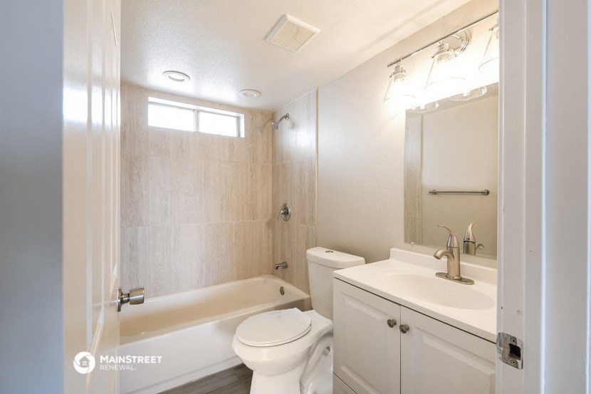 a bathroom with a sink toilet and a tub