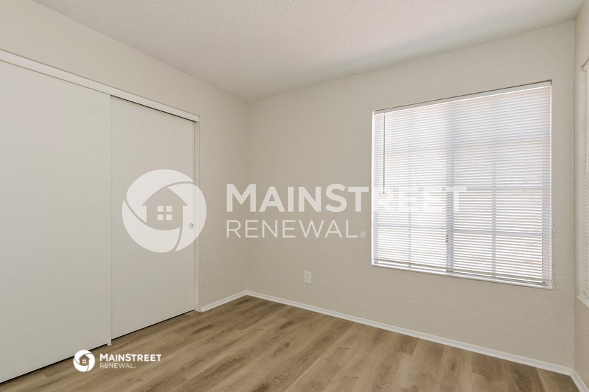 a bedroom with a closet and a window