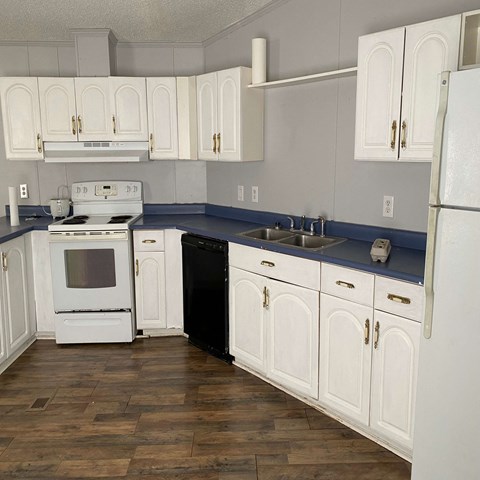 A kitchen with white cabinets and a black dishwasher.