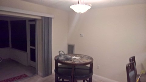 a dining room with a table and a light