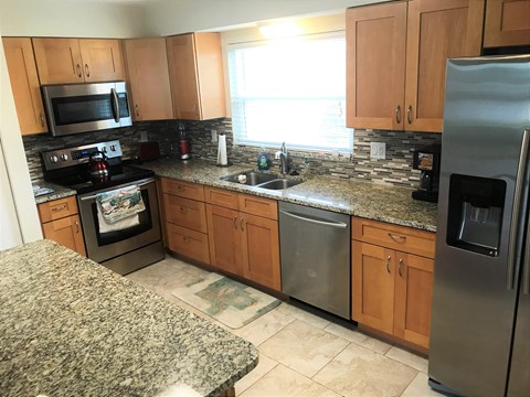 a kitchen with granite counter tops and stainless steel appliances