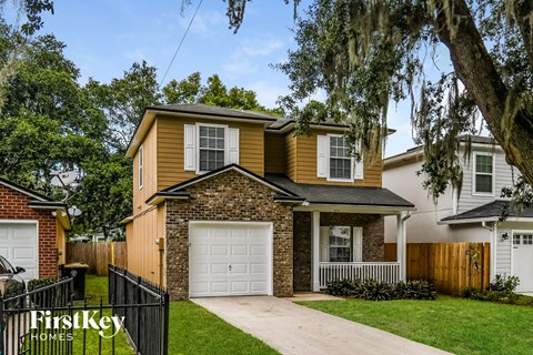 a yellow house with a white garage door