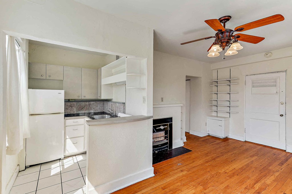 a kitchen with an island and a ceiling fan