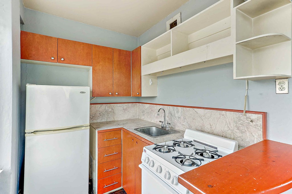a kitchen with a stove and a refrigerator