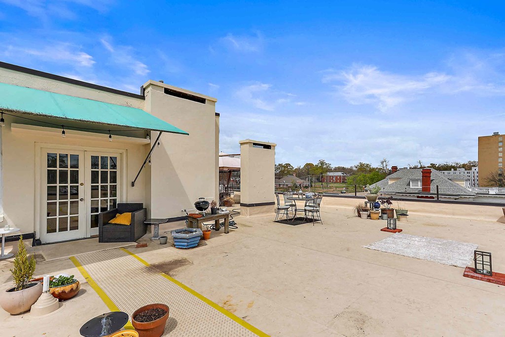 the rooftop patio of the building has seating and tables
