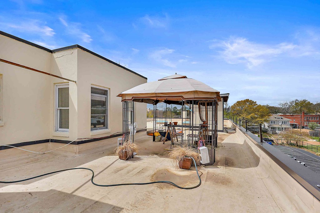 a gas pump is on the patio of a house with a roof