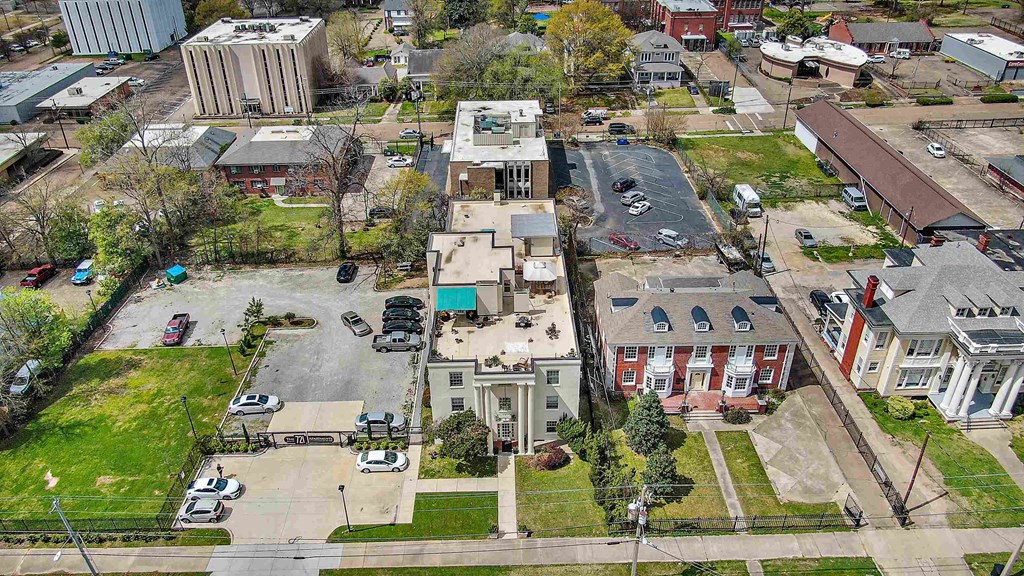 an aerial view of a city street with buildings and cars