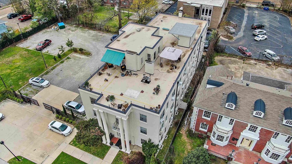an aerial view of an apartment building with a parking lot