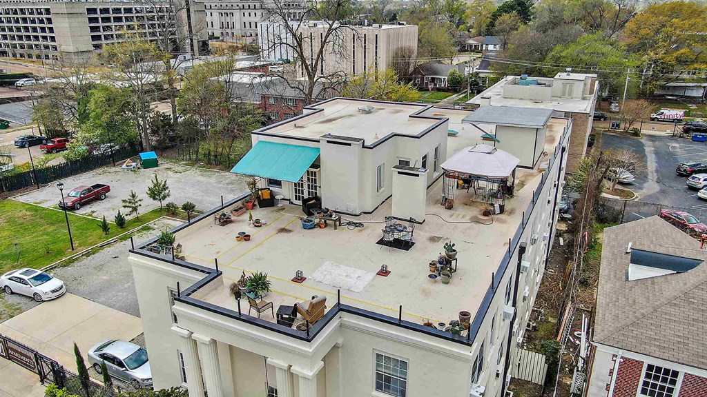 an aerial view of a large white building in a city