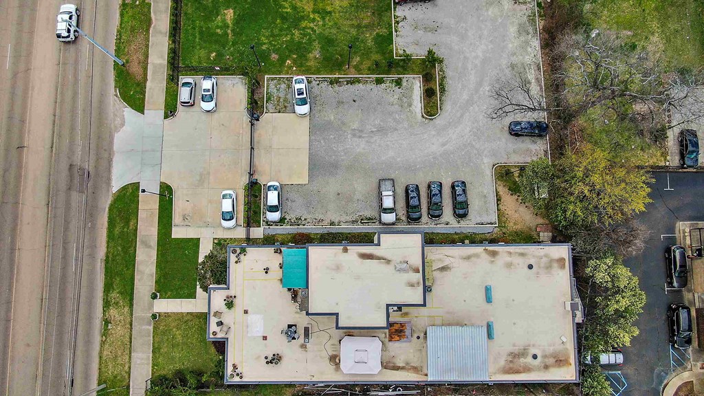 an aerial view of the roof of a building with cars parked on it