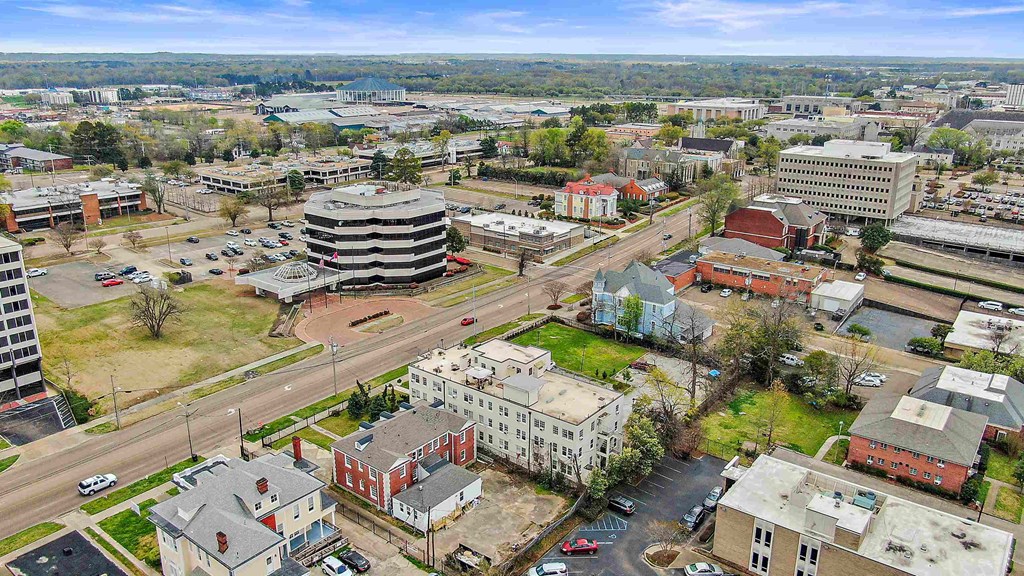 an aerial view of a city with a street and buildings