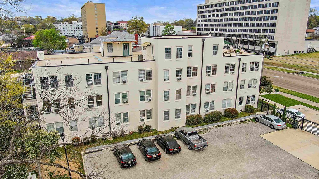 a large white building with cars parked in front of it