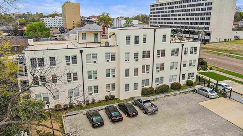 a large white building with cars parked in front of it