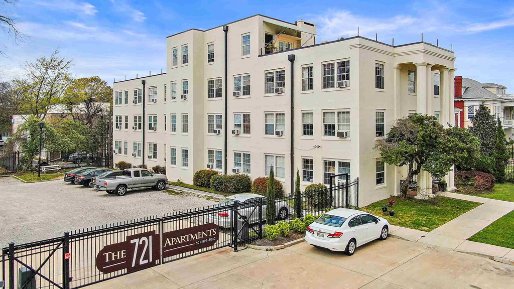 an apartment building with cars parked in front of it