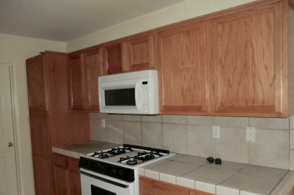 a kitchen with a stove and a microwave