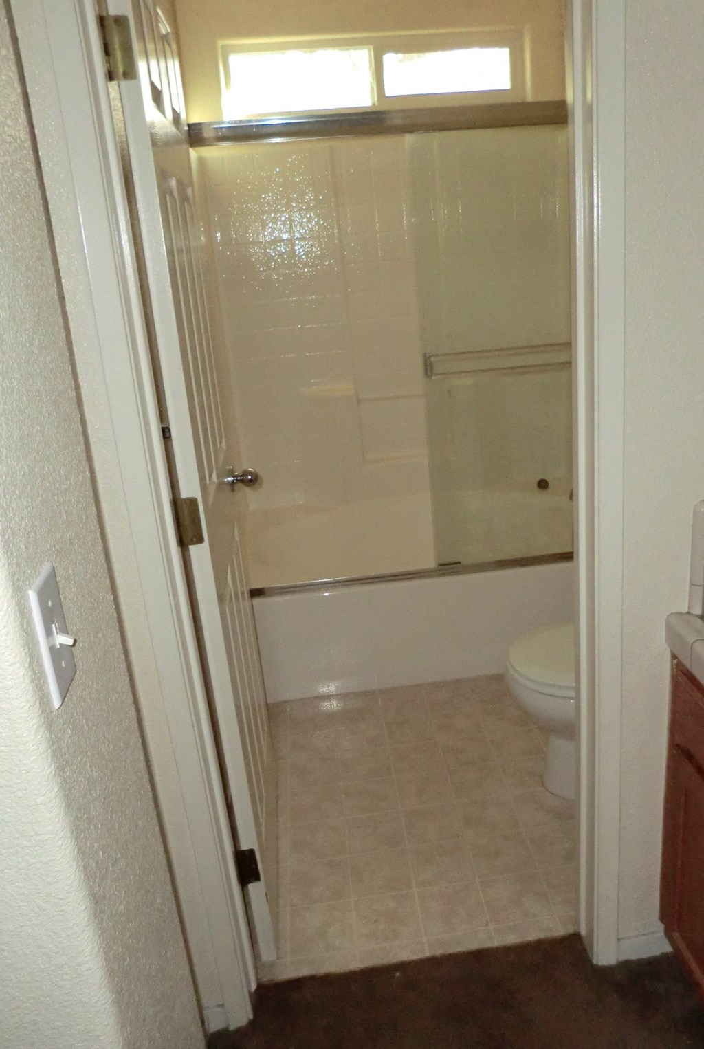 the bathroom has a shower and a toilet in it