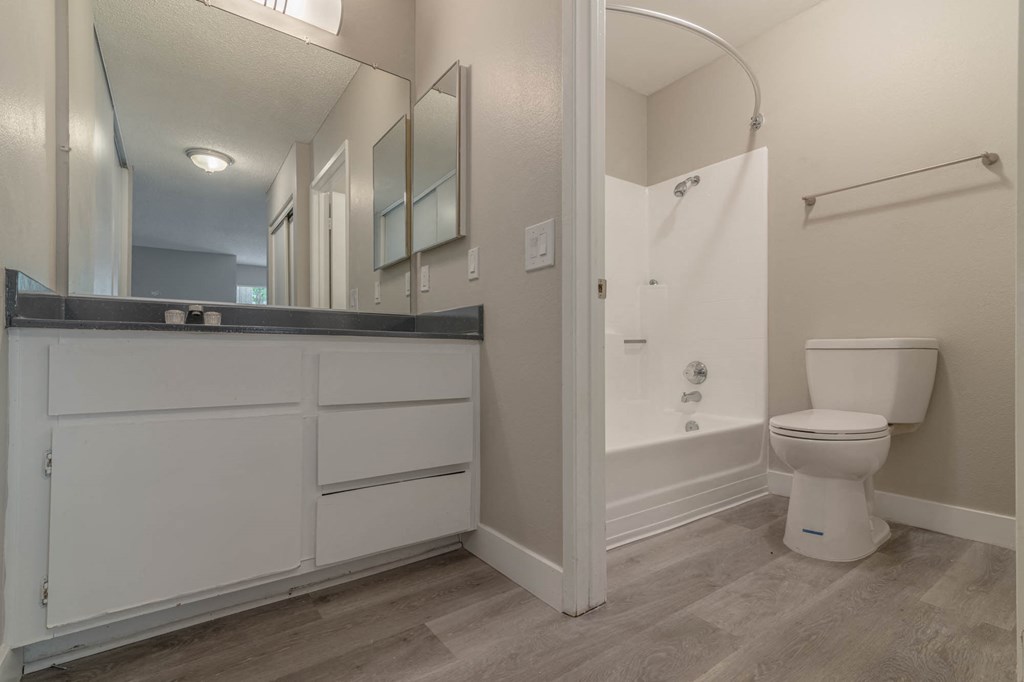 a bathroom with a toilet and a shower and a sink