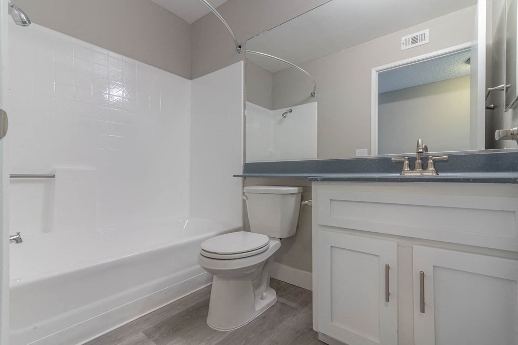 a white bathroom with a toilet and a sink
