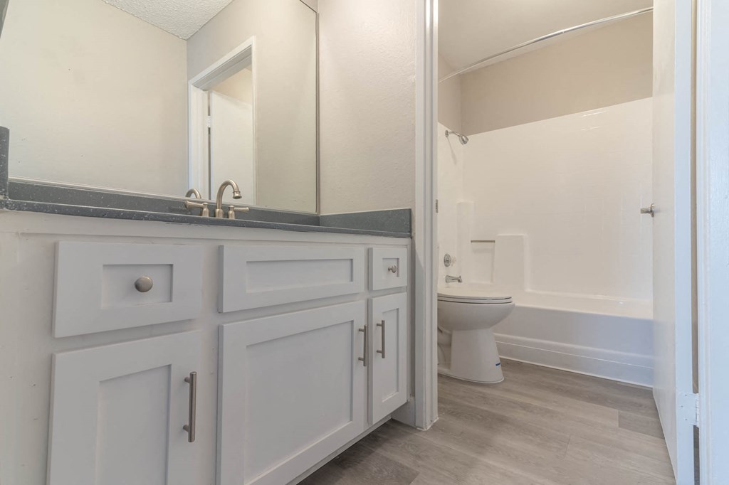 a white bathroom with a toilet and a sink