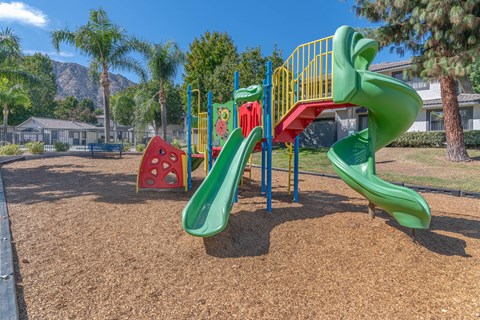 a playground with a slide at a park