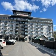 A large building with a balcony on the top floor.