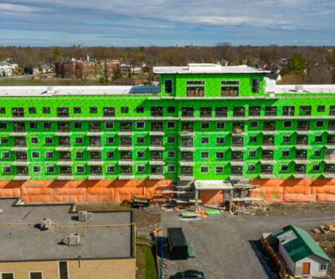 an aerial view of a large building covered in green spray paint