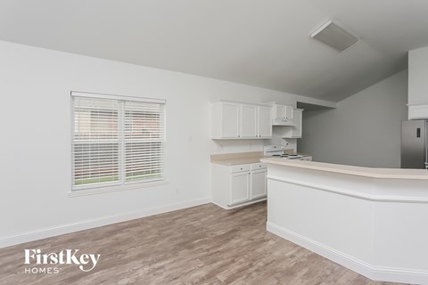 A kitchen area with a counter and cabinets.
