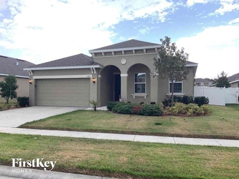 A house with a garage and a driveway is shown.
