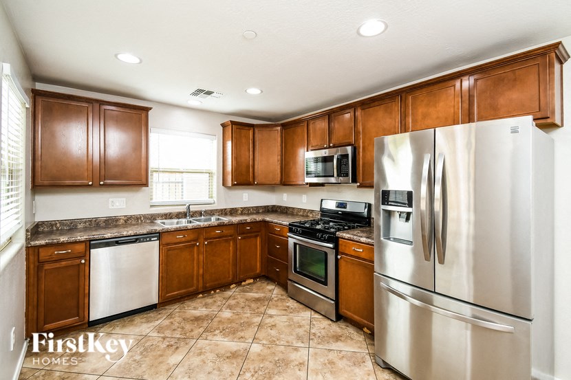 a kitchen with stainless steel appliances and wooden cabinets