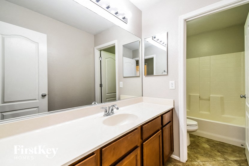 a bathroom with a large mirror and a sink