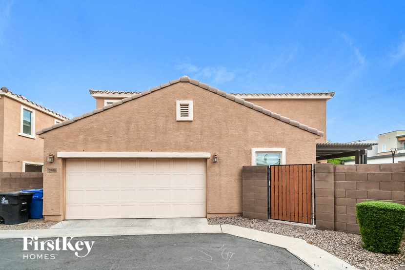 a garage door in front of a brick house with a driveway