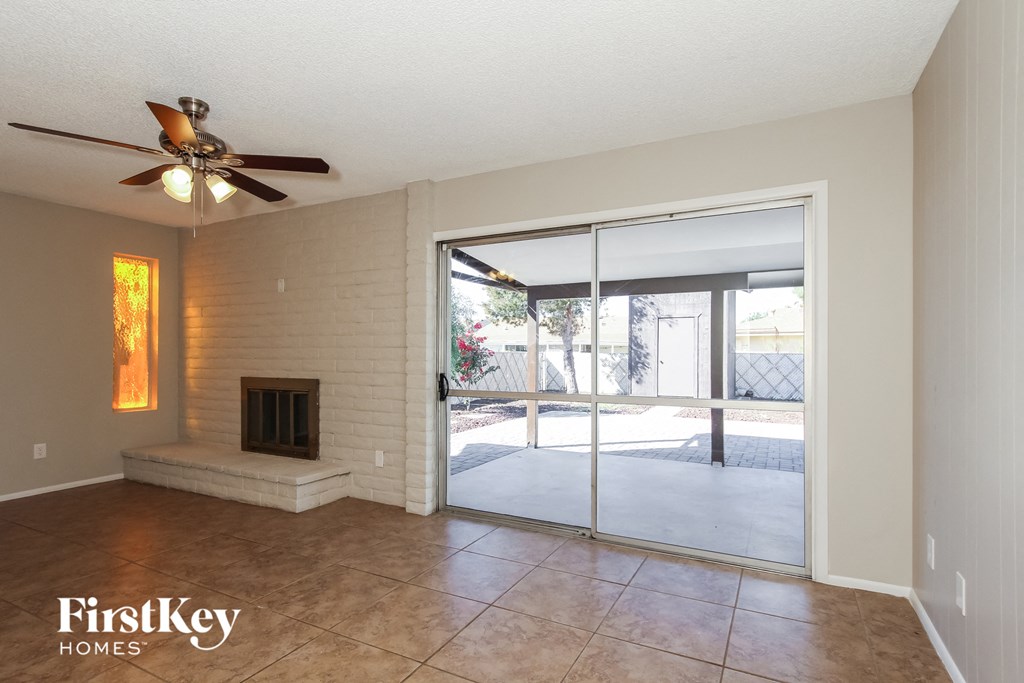 A room with a fireplace and sliding glass doors.