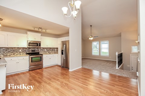 A kitchen with a stove top oven and a microwave.