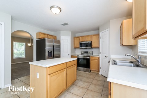 a kitchen with wooden cabinets and stainless steel appliances
