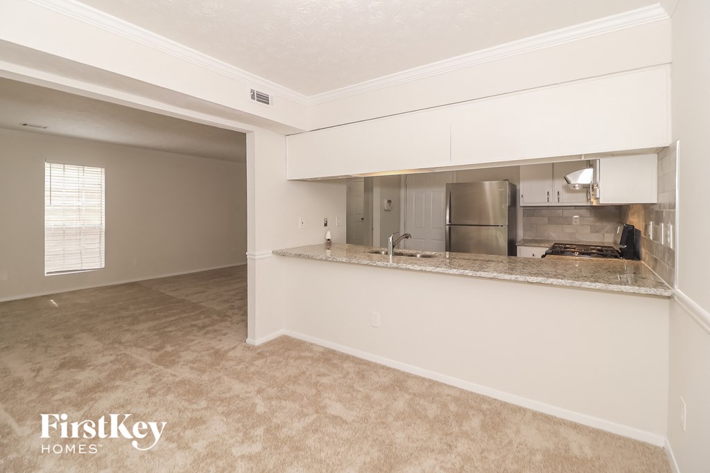 A kitchen area with a countertop and a window.