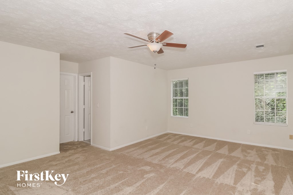 A room with a fan and a door.