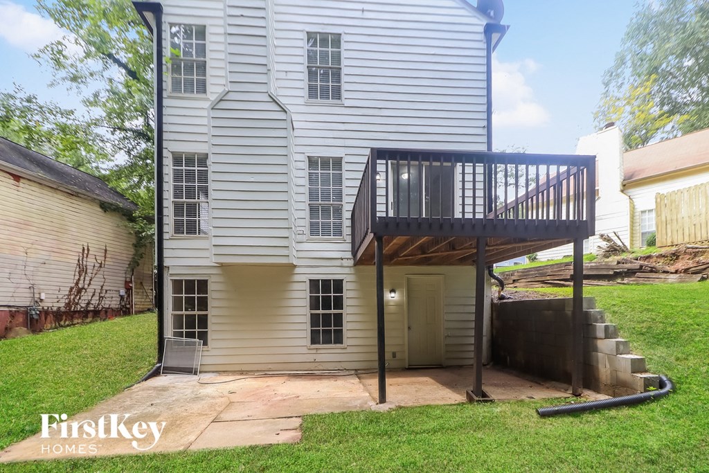 A house with a balcony and a staircase leading to it.