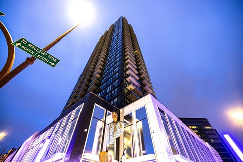 a tall building with a street sign in front of it