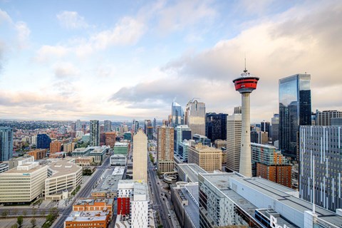 a city skyline with the calgary tower and other buildings