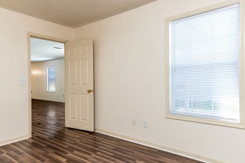 an empty room with a door and a window