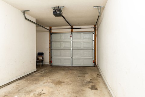 a garage with white walls and a white garage door
