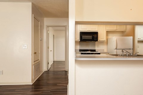 a view of a kitchen and a hallway in a house